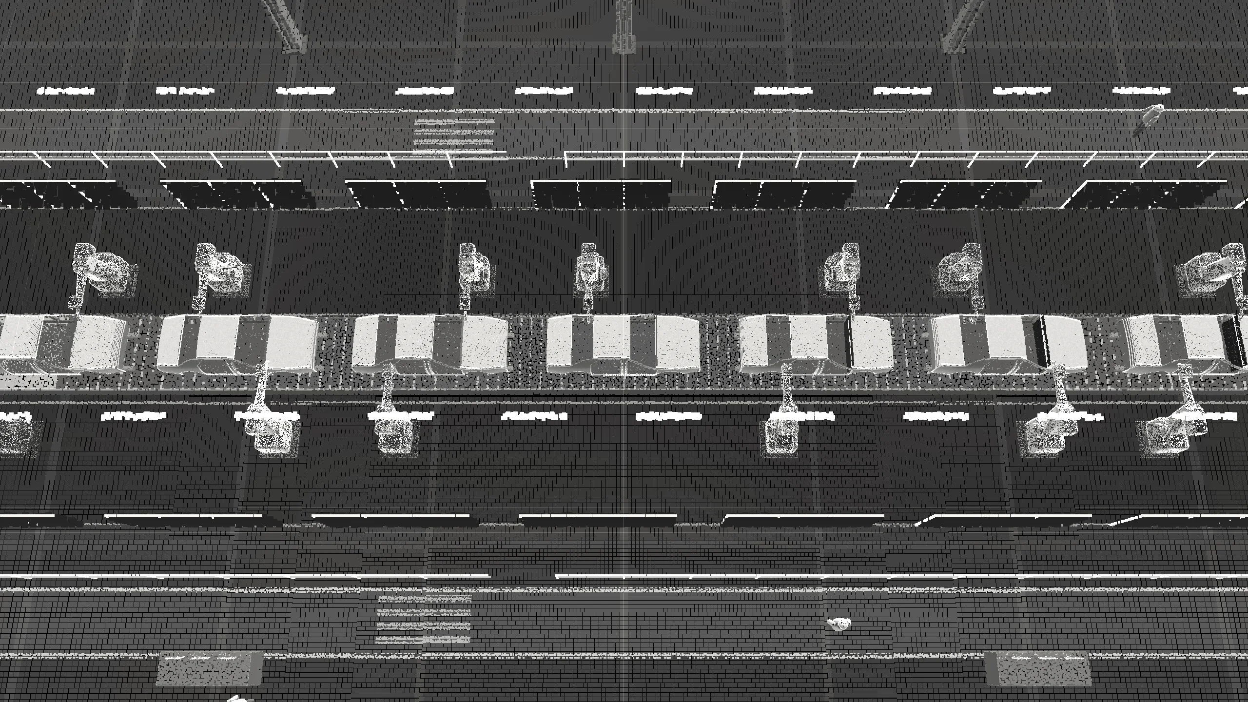 Ligne d’assemblage automobile vue en hauteur : caisses en blanc sur convoyeur, robots de soudage, barrières